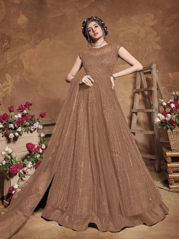 Get Ready For The Upcoming Wedding Season With This Attractive Looking Heavy Designer Floor Length Suit In Fawn Color. This Pretty Heavy Embroidered Suit Is Fabricated On Butterfly Net Paired With Bangal Ore Silk Bottom And Butterfly Net Fabricated Dupatta. Its Bright Color And Heavy Embroidery Will Give An Attractive Look To Your Personality.