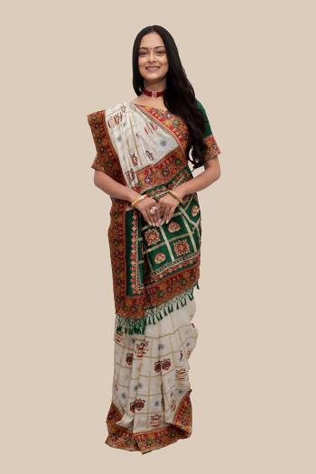 Celebrate This Festive Season In This Very Pretty Patola Designer Saree Paired With Contrasting Blouse. This Saree Are Soft Silk and Blouse Are Fentam Silk Based Beautified With Detailed Heavy Embroidery With Diamond Work And Latkan. 