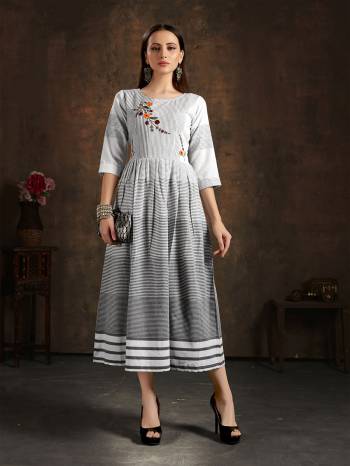 Grab This Readymade Long Kurti In Fine Color Fabricated On Cotton Wevon Chex Beautified With Hand Embroidery Work. It Is Light In Weight And Easy To Carry All Day Long. 