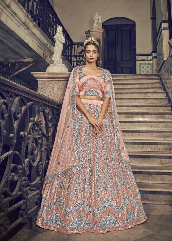 Attrective Bridal Partywear Heavy Designer Lehenga Choli And Dupatta In Peach Color Fabricated On Net Beautified With Heavy Attractive Seaqoance Embroidery Work. 