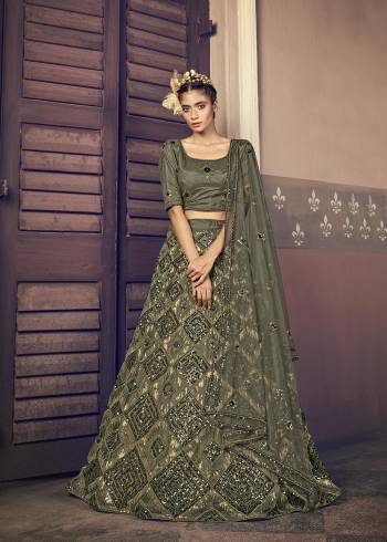 Attrective Bridal Partywear Heavy Designer Lehenga Choli And Dupatta In Olive Green Color Fabricated On Net Beautified With Heavy Attractive Seaqoance Embroidery Work. 