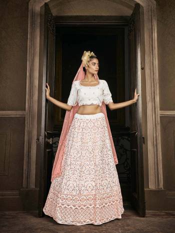 Attrective Bridal Partywear Heavy Designer Lehenga Choli In Light Color Fabricated On Georgette Beautified And Dupatta Are Net With Heavy Attractive Seaqoance Embroidery Work. 