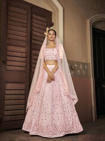 Attrective Bridal Partywear Heavy Designer Lehenga Choli In Light Color Fabricated On Georgette Beautified And Dupatta Are Net With Heavy Attractive Seaqoance Embroidery Work. 