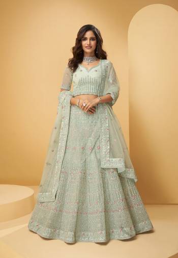 Attrective Bridal Partywear Heavy Designer Lehenga Choli And Dupatta In Lignt Color Fabricated On Net Beautified With Heavy Attractive Cording,Thread,Seaquance Embroidery With Hand Zarkan Work. 