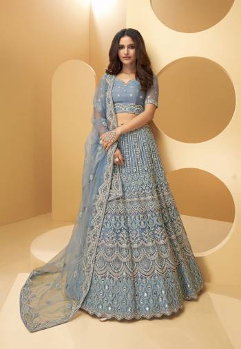 Attrective Bridal Partywear Heavy Designer Lehenga Choli And Dupatta In Lignt Color Fabricated On Net Beautified With Heavy Attractive Cording,Thread,Seaquance Embroidery With Hand Zarkan Work. 