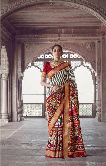 Garb This Partywear Saree Are Fine Saree Paired With Contrasted Blouse.This Saree And Blouse Are Patola Silk With Heavy Wevon Designer Work Based Fabric. Buy This Pretty Saree Now.