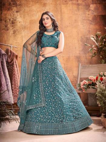 Garb This Partywear Heavy Designer Lehenga Choli And Dupatta In Fancy Color Fabricated On Soft Net Beautified With Heavy Attractive  Thread,Sequance Embroidery Work. 