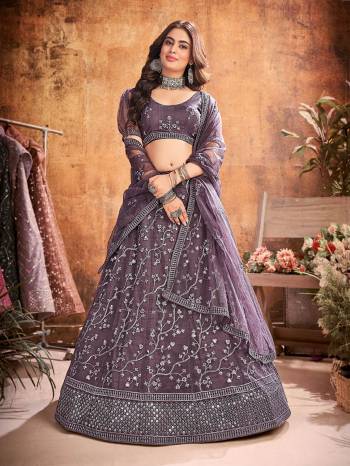 Garb This Partywear Heavy Designer Lehenga Choli And Dupatta In Fancy Color Fabricated On Soft Net Beautified With Heavy Attractive  Thread,Sequance Embroidery Work. 