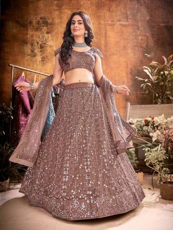 Garb This Partywear Heavy Designer Lehenga Choli And Dupatta In Fancy Color Fabricated On Soft Net Beautified With Heavy Attractive  Thread,Sequance Embroidery Work. 