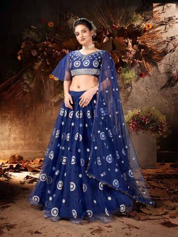 Garb This Partywear Heavy Designer Lehenga Choli And Dupatta In Fancy Color Fabricated On Soft Net Beautified With Heavy Attractive Mirror,Gota And Jari Embroidery Work. 