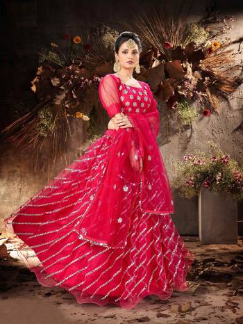 Garb This Partywear Heavy Designer Lehenga Choli And Dupatta In Fancy Color Fabricated On Soft Net Beautified With Heavy Attractive Mirror,Gota And Jari Embroidery Work. 