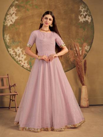 Flaunt Your Rich And Elegant Taste Wearing This Designer Long Gown In Light Color. This Pretty Gown Is Fabricated On Net Beautified With Metalic Foil Work. Its Fabric Is Soft Towards Skin And Easy To Carry All Day Long. 