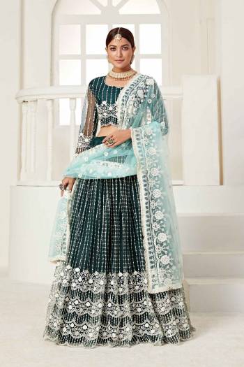 Garb This Partywear Heavy Designer Lehenga Choli And Dupatta In Fine Color Fabricated On Net Beautified Fabric With Designer Sequance,Cotton Thread Embroidery Work. 