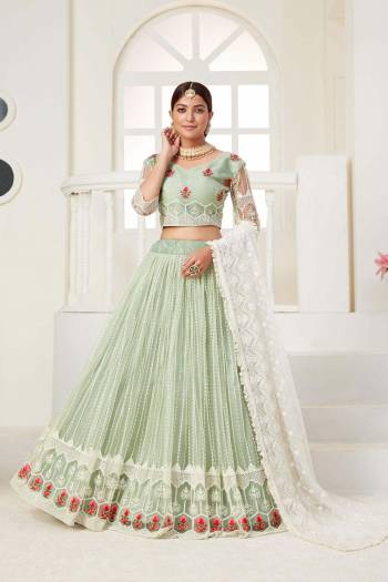 Garb This Partywear Heavy Designer Lehenga Choli And Dupatta In Fine Color Fabricated On Net Beautified Fabric With Designer Sequance,Cotton Thread Embroidery Work. 