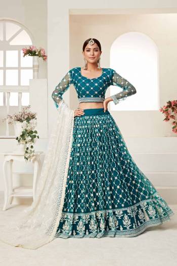 Garb This Partywear Heavy Designer Lehenga Choli And Dupatta In Fine Color Fabricated On Net Beautified Fabric With Designer Sequance,Cotton Thread Embroidery Work. 