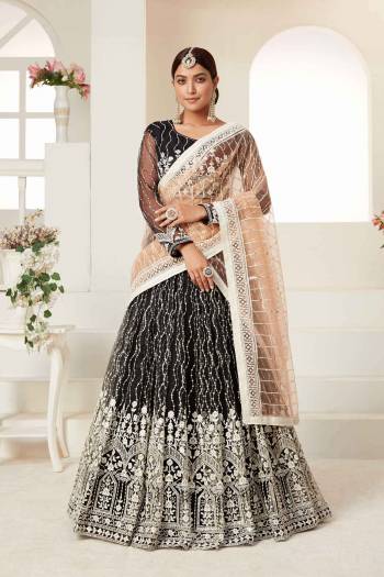 Garb This Partywear Heavy Designer Lehenga Choli And Dupatta In Fine Color Fabricated On Net Beautified Fabric With Designer Sequance,Cotton Thread Embroidery Work. 