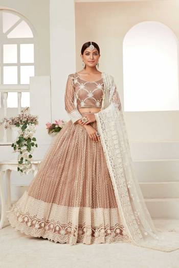 Garb This Partywear Heavy Designer Lehenga Choli And Dupatta In Fine Color Fabricated On Net Beautified Fabric With Designer Sequance,Cotton Thread Embroidery Work. 