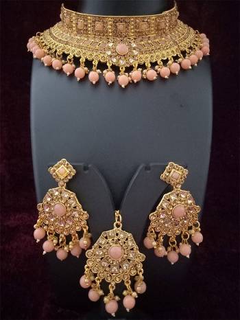 An Enhanced Look To Your Personality By Pairing Up This Beautiful Necklace Set With Your Ethnic Attire. This Pretty Set Is In Golden Color Beautified With Amond,Kundan And Pearl MotiWork. Buy Now.