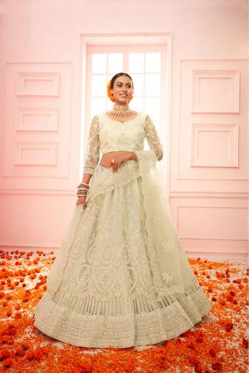 Garb This Partywear Heavy Designer Lehenga Choli And Dupatta In Fancy Color Fabricated On Net Beautified With Butterfly Net Dupatta And Heavy Attractive Cording,Thread Embroidery With Stone Work. 