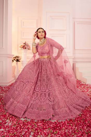 Garb This Partywear Heavy Designer Lehenga Choli And Dupatta In Fancy Color Fabricated On Net Beautified With Butterfly Net Dupatta And Heavy Attractive Cording,Thread Embroidery With Stone Work. 