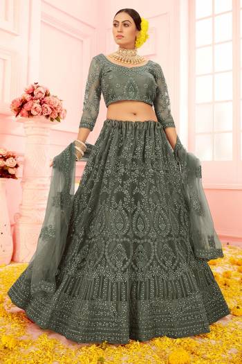 Garb This Partywear Heavy Designer Lehenga Choli And Dupatta In Fancy Color Fabricated On Net Beautified With Butterfly Net Dupatta And Heavy Attractive Cording,Thread Embroidery With Stone Work. 