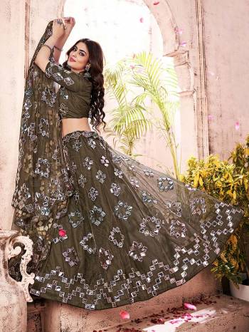 Garb This Partywear Heavy Designer Lehenga Choli And Dupatta In Fine Color Fabricated On Soft Net Beautified Fabric With Designer Thread,Foil,Mirror And Gota Embroidery Work. 