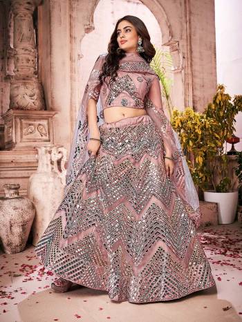 Garb This Partywear Heavy Designer Lehenga Choli And Dupatta In Fine Color Fabricated On Soft Net Beautified Fabric With Designer Thread,Foil,Mirror And Gota Embroidery Work. 