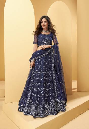 Garb This Wedding Partywear Heavy Designer Lehenga Choli And Dupatta In Fancy Color Fabricated On Net Beautified With Butterfly Net Dupatta And Heavy Attractive Thread,Mirror Embroidery With Zarkan Work. 