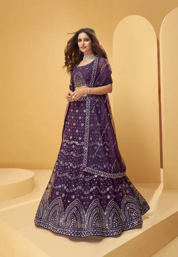 Garb This Wedding Partywear Heavy Designer Lehenga Choli And Dupatta In Fancy Color Fabricated On Net Beautified With Butterfly Net Dupatta And Heavy Attractive Thread,Mirror Embroidery With Zarkan Work. 