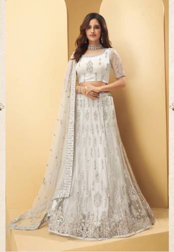 Garb This Wedding Partywear Heavy Designer Lehenga Choli And Dupatta In Fancy Color Fabricated On Net Beautified With Butterfly Net Dupatta And Heavy Attractive Thread,Mirror Embroidery With Zarkan Work. 