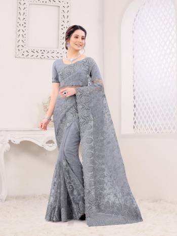 Attrective Look This Fastival Partywear Saree Are Fine Saree Paired With Blouse.This Saree And Blouse Are Net Based Fabric With Heavy Designer Reshan And Coding Embroidery,Zarkan Stone Work. Buy This Pretty Saree Now.