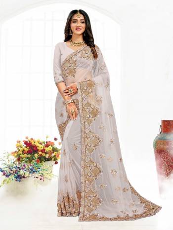 Looking This Partywear Saree Are Fine Saree Paired With Blouse.This Saree And Blouse Are Net Fabric With Heavy Designer Embroidery And Zarkan Stone Work. Buy This Pretty Saree Now.