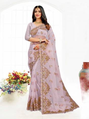 Looking This Partywear Saree Are Fine Saree Paired With Blouse.This Saree And Blouse Are Net Fabric With Heavy Designer Embroidery And Zarkan Stone Work. Buy This Pretty Saree Now.