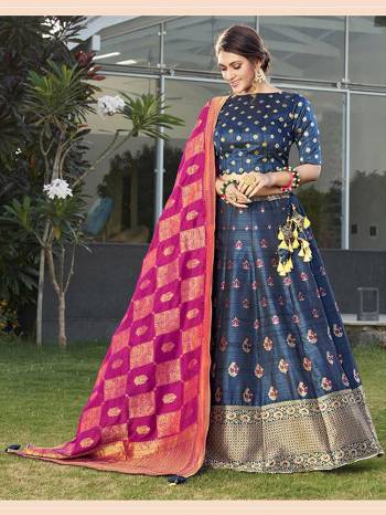 Garb This Partywear Designer Lehenga Choli And Dupatta In Fine Color Fabricated On Silk Beautified Fabric With Heavy Designer Weaving Butti Border Work. 
