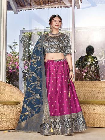 Garb This Partywear Designer Lehenga Choli And Dupatta In Fine Color Fabricated On Silk Beautified Fabric With Heavy Designer Weaving Butti Border Work. 