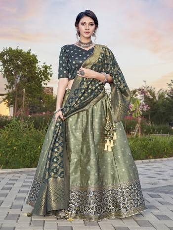 Garb This Partywear Designer Lehenga Choli And Dupatta In Fine Color Fabricated On Silk Beautified Fabric With Heavy Designer Weaving Butti Border Work. 