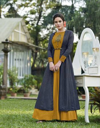 This Festive Season Look Beautiful And Feel Comfortable Wearing This Designer Gown In Musturd Yellow Color Paired With Attractive Blue Colored Jacket Fabricated On Tussar Art Silk.  