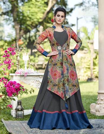 Go Colorful With This Designer Gown In Grey Color Paired With A Multi Colored Jacket Fabricated On Tussar Art Silk Beautified With Prints And Accessories. 