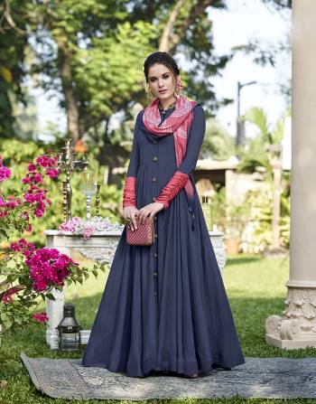 Here Is An Elegant Looking Designer Gown In Blue Color Paired With A Very Pretty Stole In Pink Color Fabricated On Soft Silk. This Gown Is Beautified With Attractive Hand Work And Fancy Buttons. 