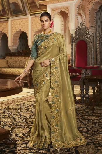 Garb This Stylist Partywear Saree Are Fine Saree Paired With Blouse.This Saree Are Viscose With Golden Smoke And Blouse Are Raw Silk Fabric With Heavy Designer Embroidery Work With Beads. Buy This Pretty Saree Now.