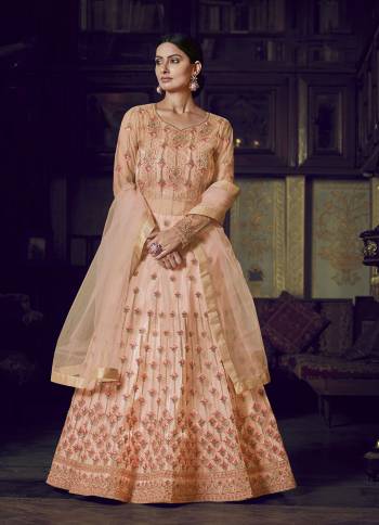 Look Pretty In This Beautiful Designer Floor Length Gown In Peach Color Paired With Peach Colored Dupatta. This Semi-Stitched Gown And Dupatta Are Fabricated On Net Beautified With Pretty Embroidery. Buy Now.