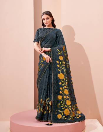 Garb This Partywear Stylist Designer Fine Colour Saree Paired With Blouse.This Saree Are Brosso And Blouse Are Raw Silk Fabric With Heavy Designer Embroidery Work. Buy This Pretty Saree Now.