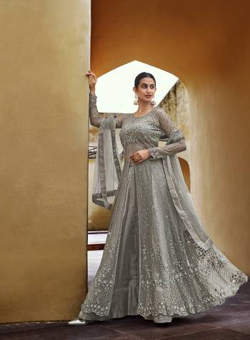 Attrective This Designer Long Length Suit In Lovely Color.Its Pretty Designer Front Back Thread Embroidery And Swaroski Work Top Is Soft Net Based Paired With Banglori Silk Bottom And Net Fabricated Dupatta Which Gives An Attractive To The Suit.