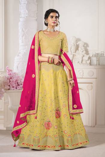 Garb This Bridal Heavy Designer Lehenga Choli In Fine lovely Color Fabricated On Choli Raw Silk Beautified Fabric Lahenga Are Silk With Heavy Designer Thread,Jari,Dori Embroidery And Khatli Work.Buy Now. 