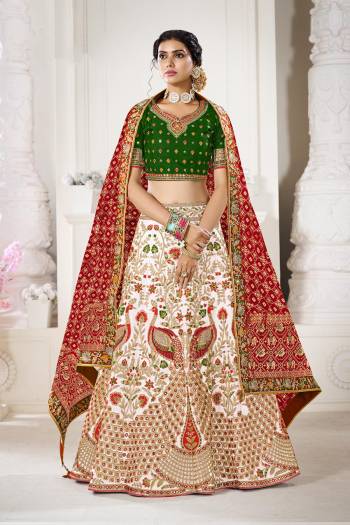 Garb This Bridal Heavy Designer Lehenga Choli In Fine lovely Color Fabricated On Choli Raw Silk Beautified Fabric Lahenga Are Silk With Heavy Designer Thread,Jari,Dori Embroidery And Khatli Work.Buy Now. 