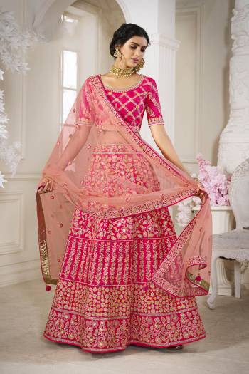 Garb This Bridal Heavy Designer Lehenga Choli In Fine lovely Color Fabricated On Choli Raw Silk Beautified Fabric Lahenga Are Silk With Heavy Designer Thread,Jari,Dori Embroidery And Khatli Work.Buy Now. 