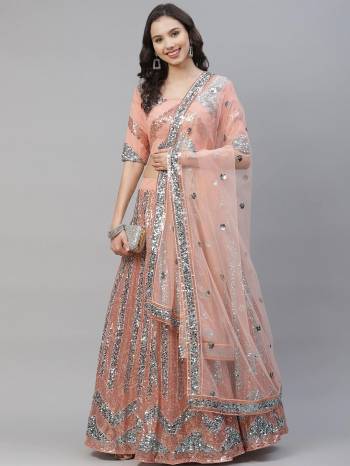 Attrective Bridal Partywear Heavy Designer Lehenga Choli And Dupatta In Peach Color Fabricated On Net Beautified With Heavy Attractive Seaqoance Embroidery Work. 