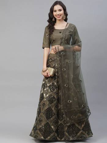 Attrective Bridal Partywear Heavy Designer Lehenga Choli And Dupatta In Olive Green Color Fabricated On Net Beautified With Heavy Attractive Seaqoance Embroidery Work. 