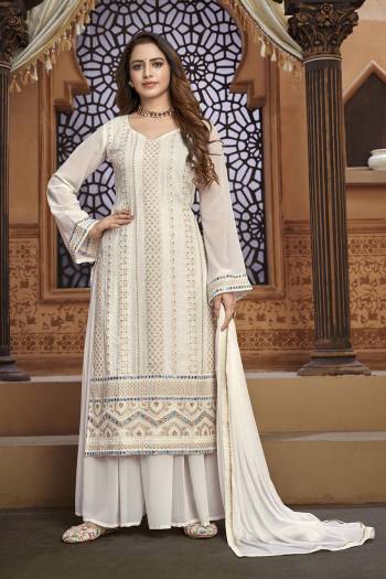 Garb This Designer Sharara Suit In Fine Color.Its Pretty Heavy Designer Thread,Mirror Embroidery Work Top Is Faux Georgette Based Paired With Faux Georgette Bottom And Naznin Fabricated Dupatta Which Gives An Attractive To The Suit.