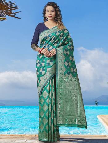 Garb This Partywear Saree Paired With Blouse.This Saree And Blouse Are Lichi Silk Based Fabric With Heavy Wevon Designer Work. Buy This Pretty Saree Now.